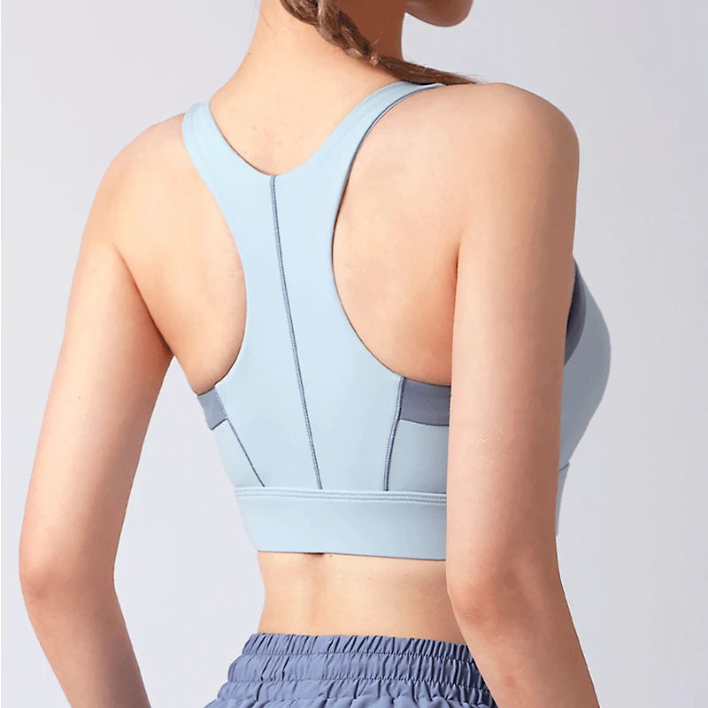 Back view of a light blue shockproof padded gym bra for women, highlighting its supportive design