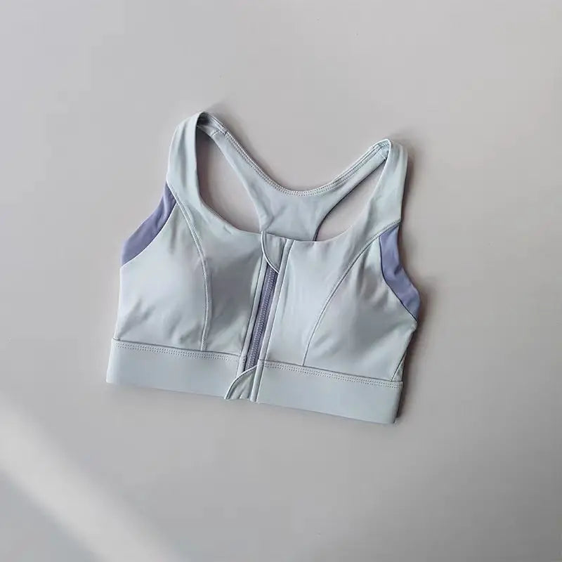Light blue shockproof padded gym bra for women with adjustable straps and back zip closure