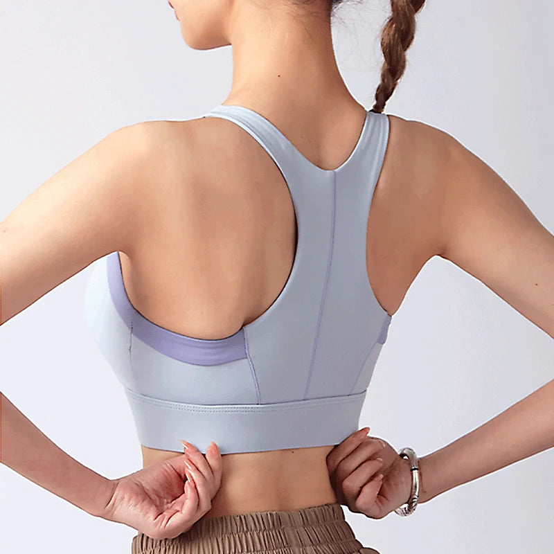 Light blue shockproof padded gym bra for women with a racerback design for active comfort
