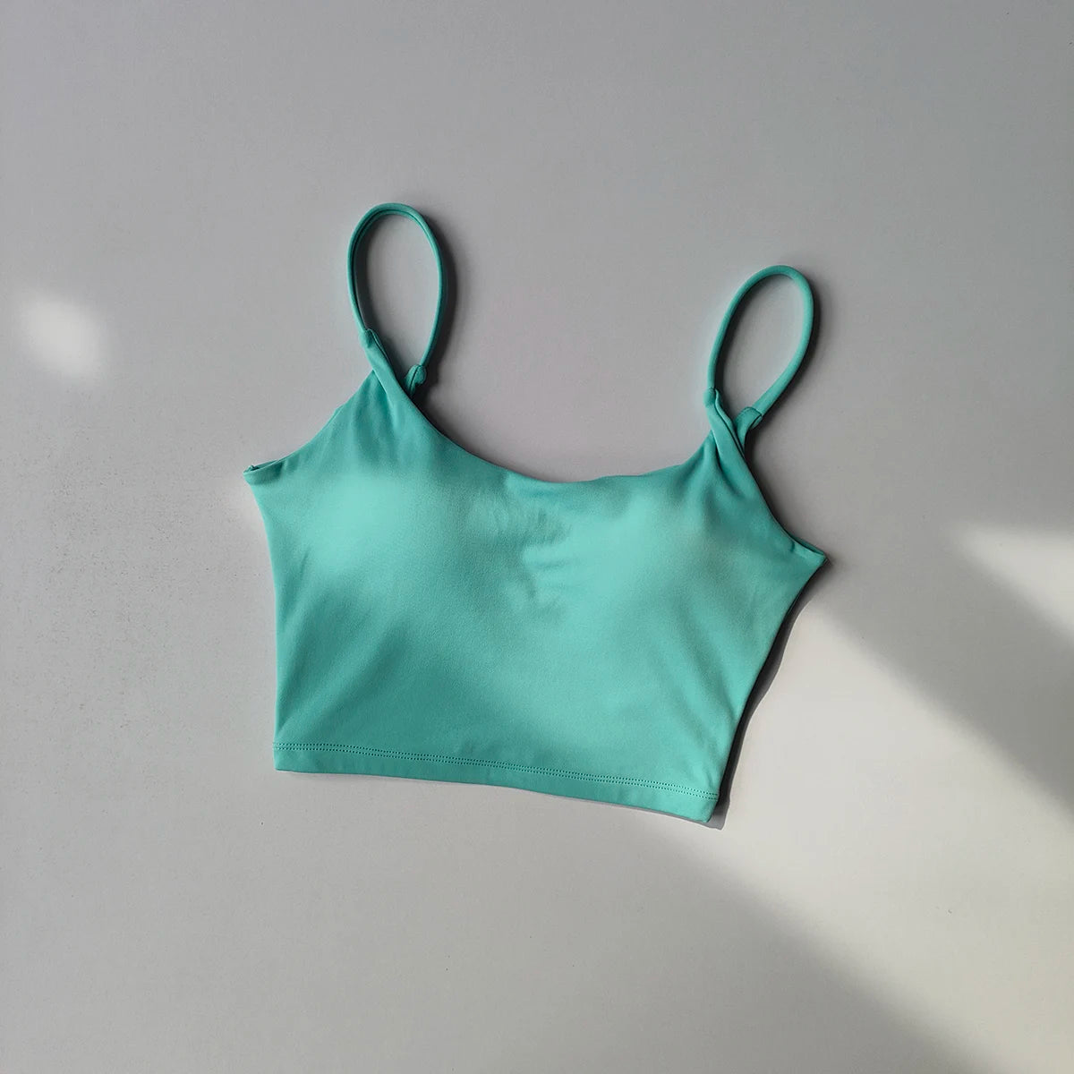 Light blue crop top designed as sports underwear for ladies with adjustable straps