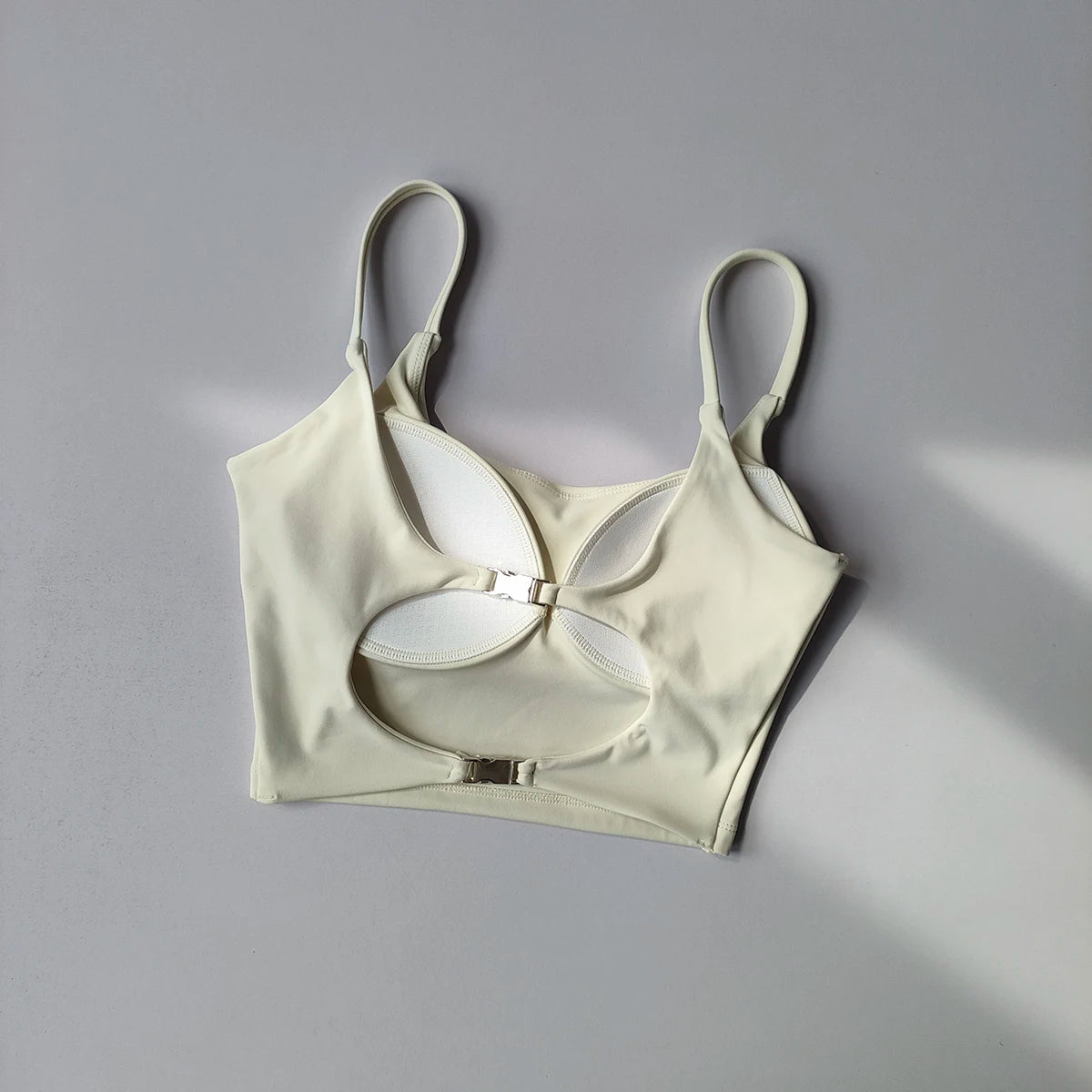 Light beige sports underwear for ladies with a stylish cutout design and adjustable straps