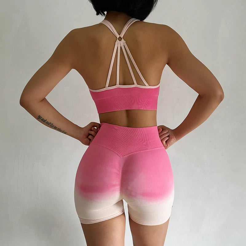 Two piece athletic wear set for women in pink and beige with a stylish back design and high-waisted shorts