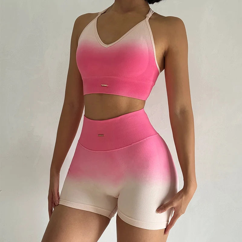Two piece athletic wear set for women in pink and beige gradient with a stylish crop top and shorts