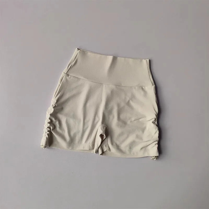 Beige drawstring sports shorts for women featuring a comfortable fit and stylish design