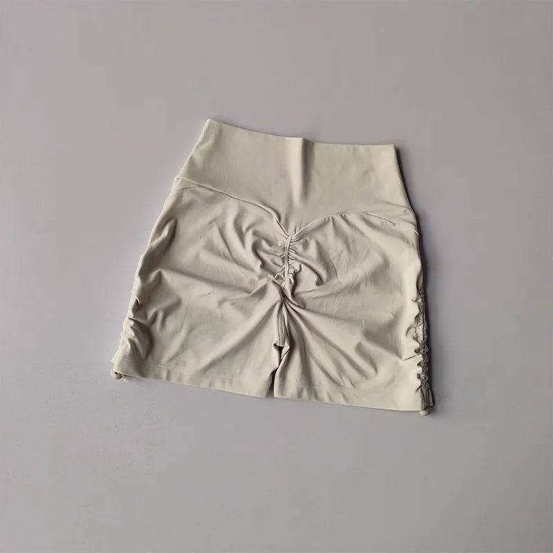 Light beige drawstring sports shorts for women with gathered sides for a flattering fit