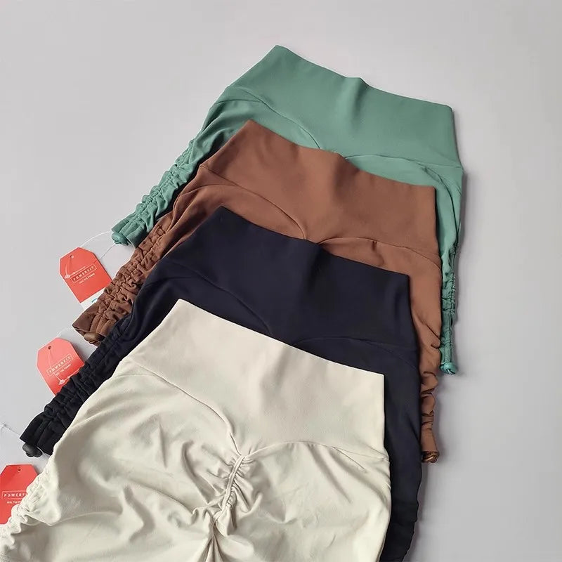 Collection of drawstring sports shorts for women in various colors including brown, green, navy, and beige