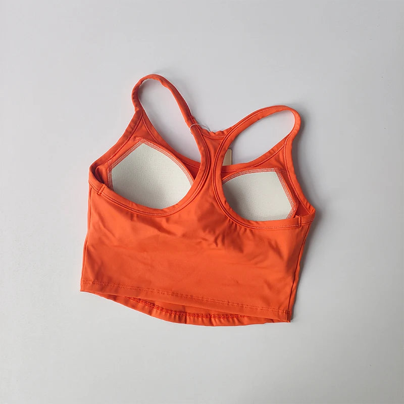 Bright orange womens push up sports bra with crisscross back design for active workouts